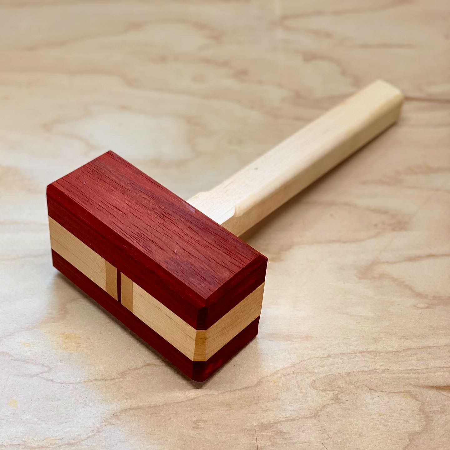 red and white wood mallet